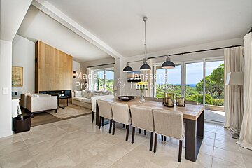 A dining room with a table and chairs and a sign that says made in provence