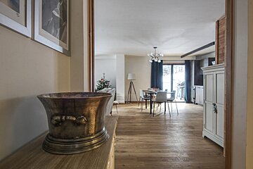 A silver bucket sits on a table in a living room