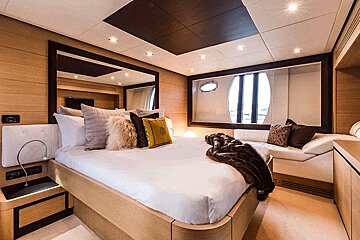A bedroom with a large bed and lots of pillows