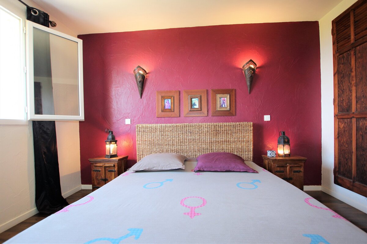 A bed with a female and male symbol on it