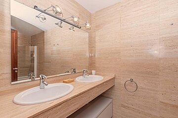 A bathroom with two sinks and a large mirror
