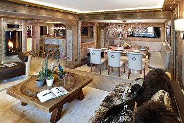A living room with a wooden table and chairs