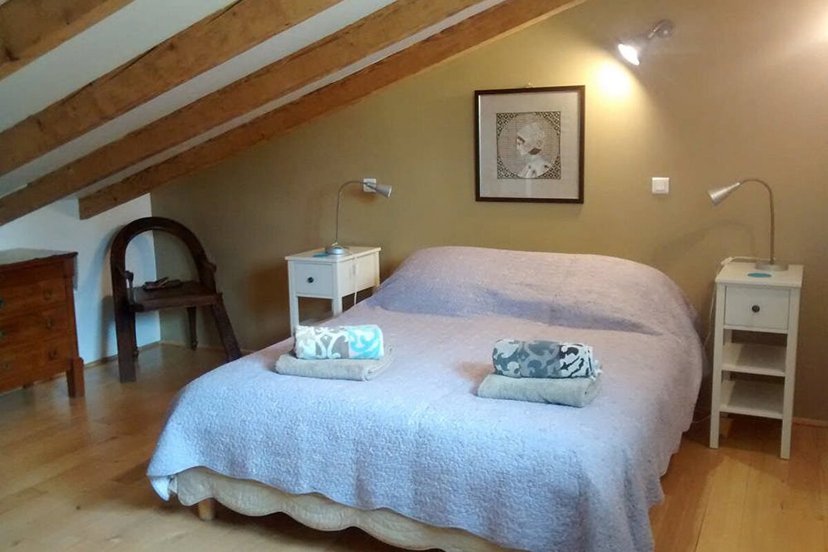 A bedroom with a large bed and two nightstands