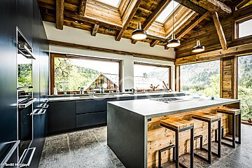 A kitchen with a large island and a skylight