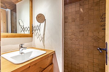 A bathroom with a sink and a mirror on the wall