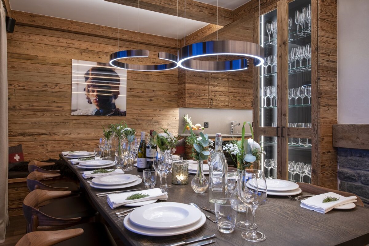 A long dining table with plates and glasses on it