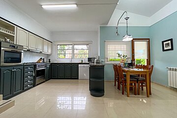 A bathroom with a large tub and a sink
