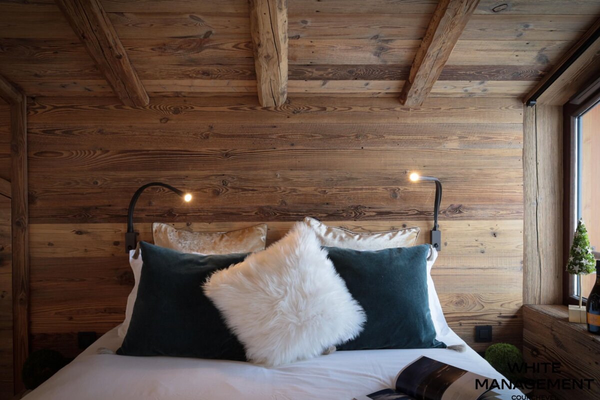 A bed with pillows and a magazine on it