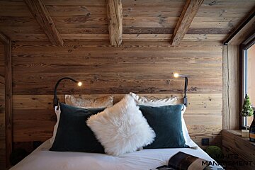 A bed with pillows and a magazine on it