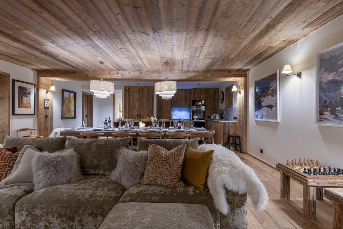 A living room with a couch and a chess board