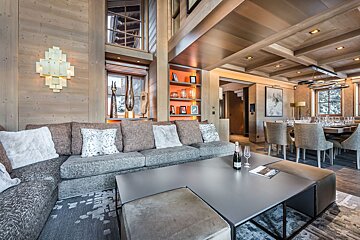 A bottle of champagne sits on a coffee table in a living room