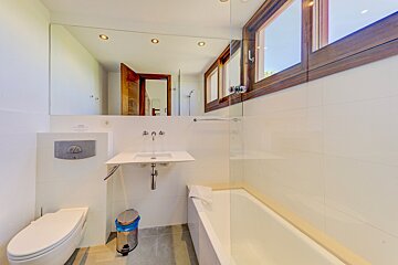 A bathroom with a toilet a sink and a bathtub