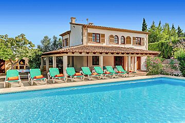 A house with a swimming pool in front of it