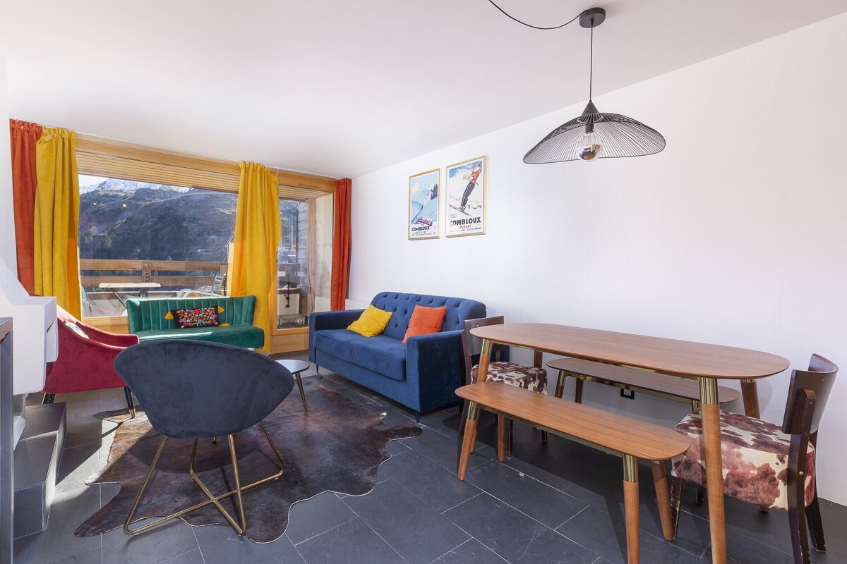 A living room with a blue couch and a table