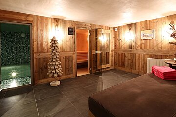 A room with wooden walls and a christmas tree