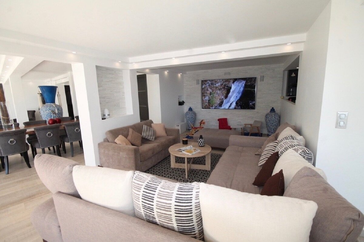 A living room with two couches and a flat screen tv