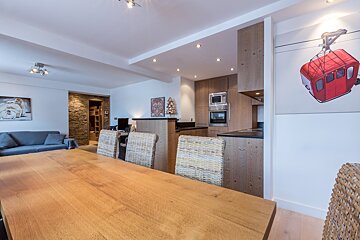 A kitchen with wooden cabinets and a stainless steel oven