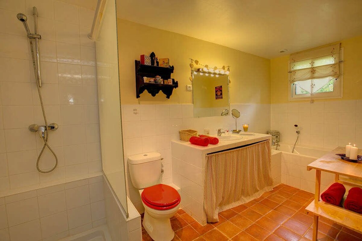 A bathroom with a toilet a sink and a bathtub
