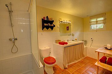 A bathroom with a toilet a sink and a bathtub