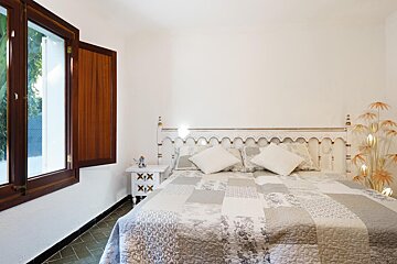 A bedroom with a bed and a nightstand with the letters xix on them