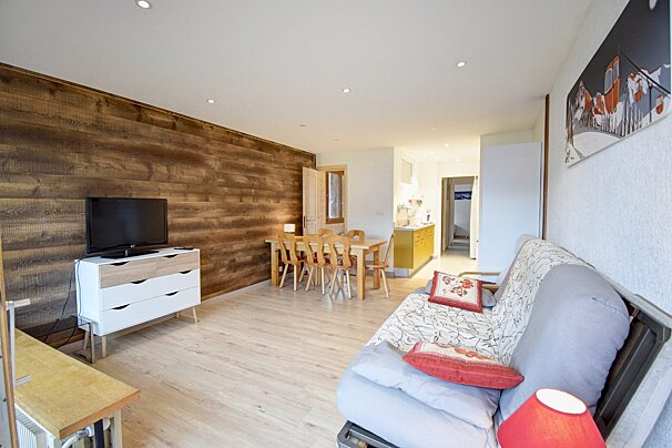 A living room with a couch and a flat screen tv