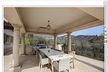 A patio with a table and chairs and a grill