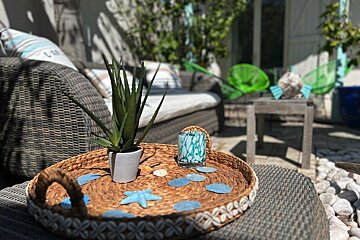 A wicker tray with seashells and starfish on it
