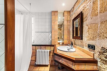 A bathroom with a sink and a mirror on the wall