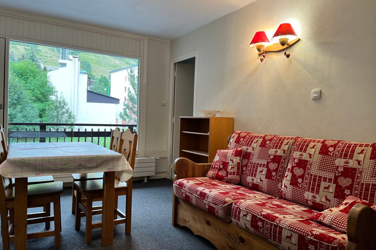 A living room with a couch a table and chairs