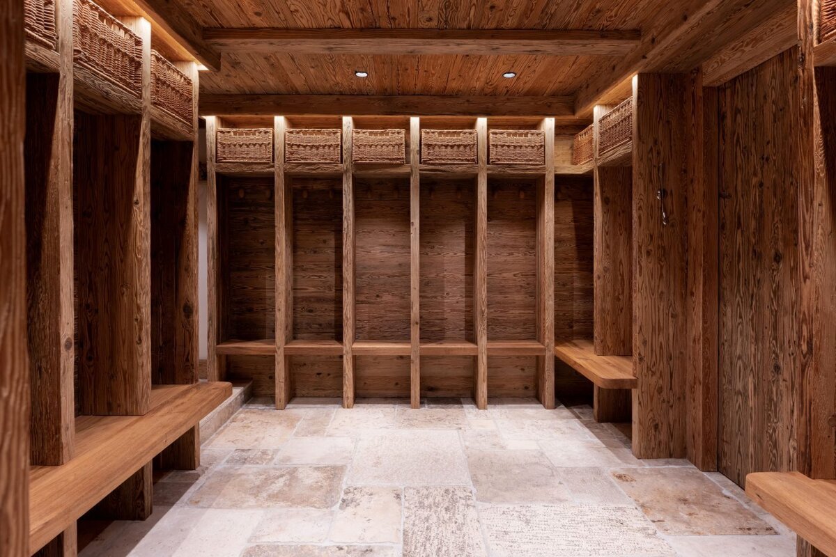 A wooden room with wicker baskets on the shelves