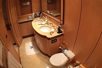 A bathroom with two sinks a toilet and a bidet