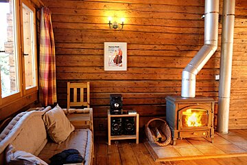A living room with a fireplace and a framed picture of a man skiing