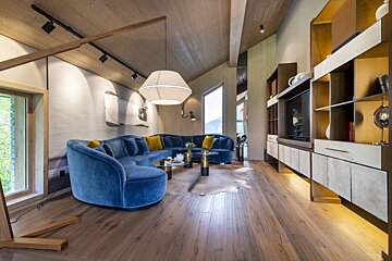 A living room with a blue couch and a table