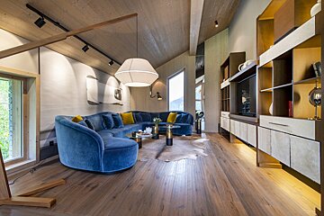 A living room with a blue couch and a table