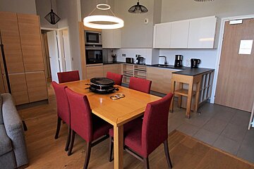 A kitchen with a table and chairs in it