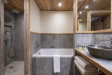 A bathroom with a bathtub and a sink