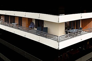 A balcony with a table and chairs on it