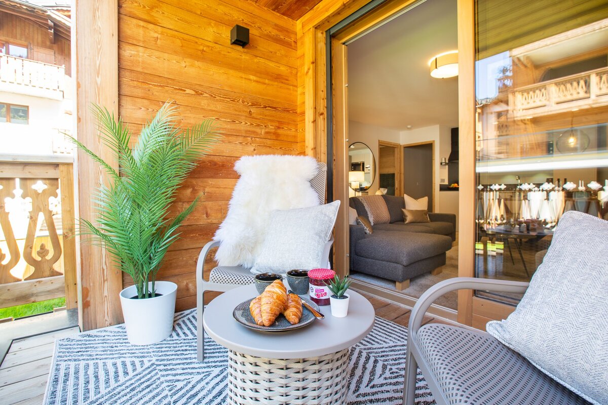 A table with a croissant and a jar of jelly on it