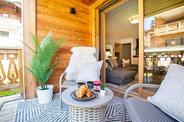 A table with a croissant and a jar of jelly on it