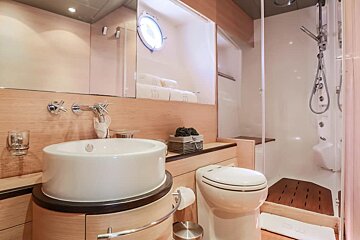 A bathroom with a toilet a sink and a mirror