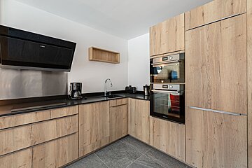 A kitchen with stainless steel appliances and wooden cabinets