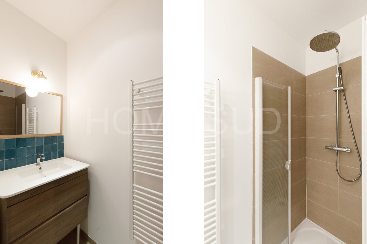 A bathroom with a sink and a shower with the word home on the bottom