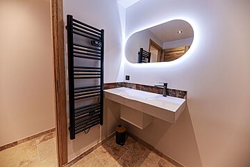 A bathroom with a sink and a towel rack