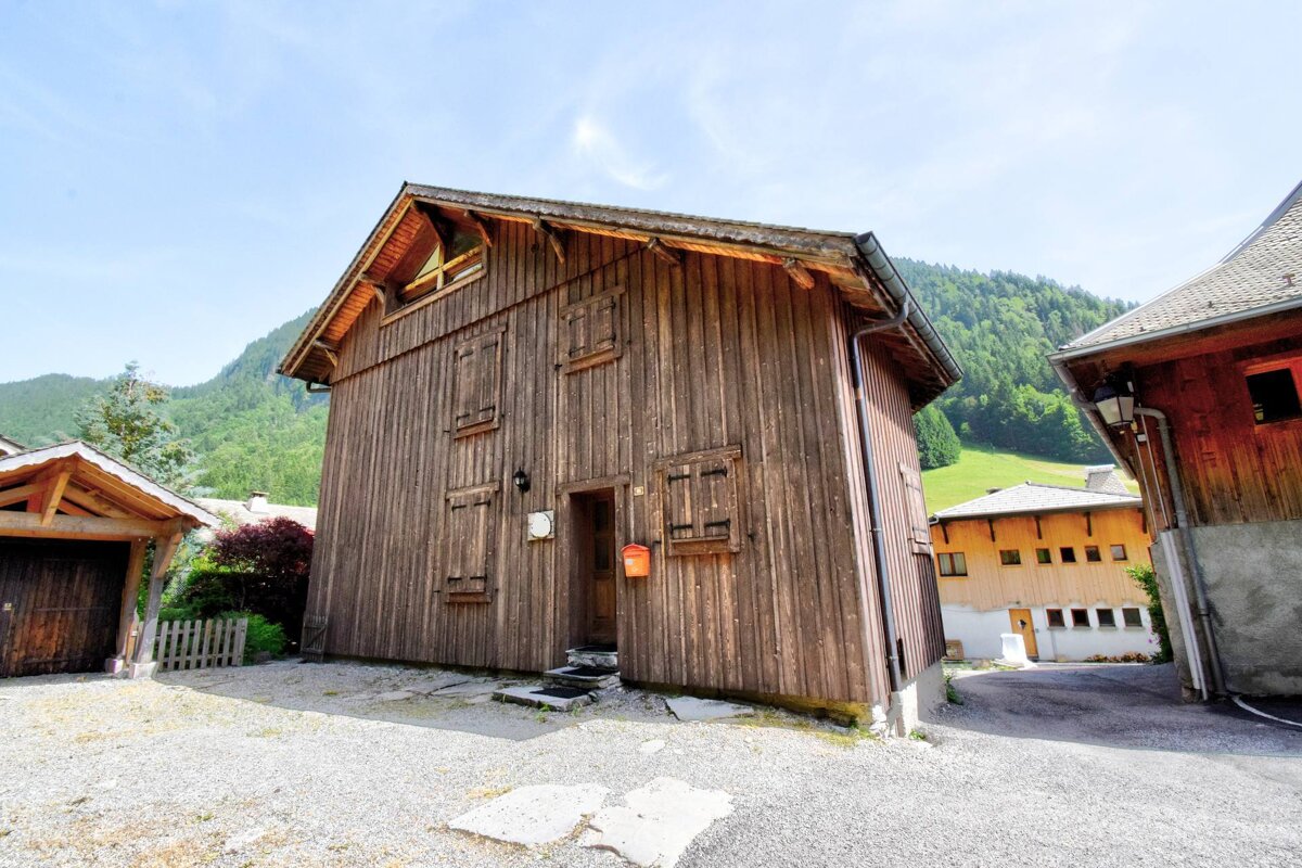 A wooden building with a mailbox in front of it