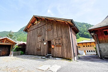 A wooden building with a mailbox in front of it