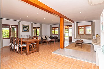 A living room with a table and chairs and a picture on the wall