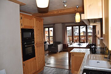 A kitchen with wooden cabinets and a black oven