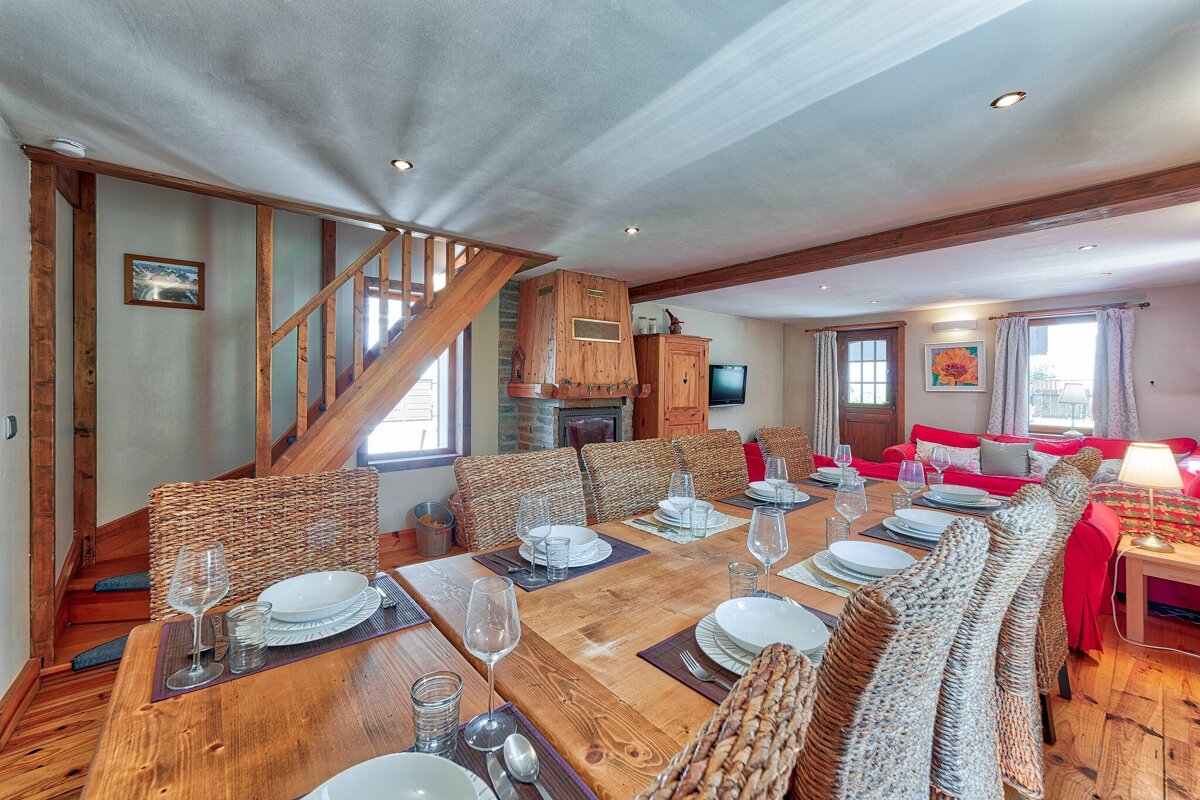 A dining room table with plates and glasses on it