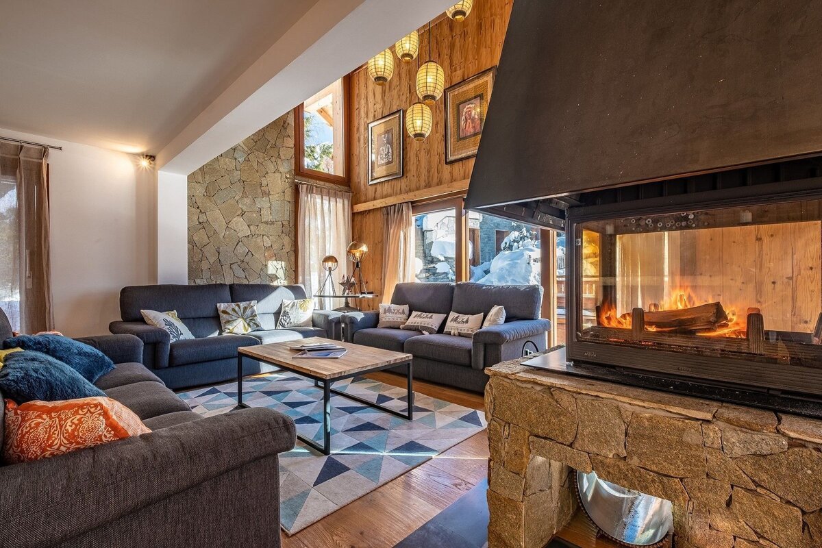 A living room with a fireplace and a couch with a pillow that says 