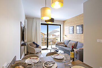 A bottle of wine sits on a table in a living room